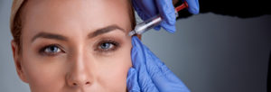 Woman receiving cosmetic procedure with syringe